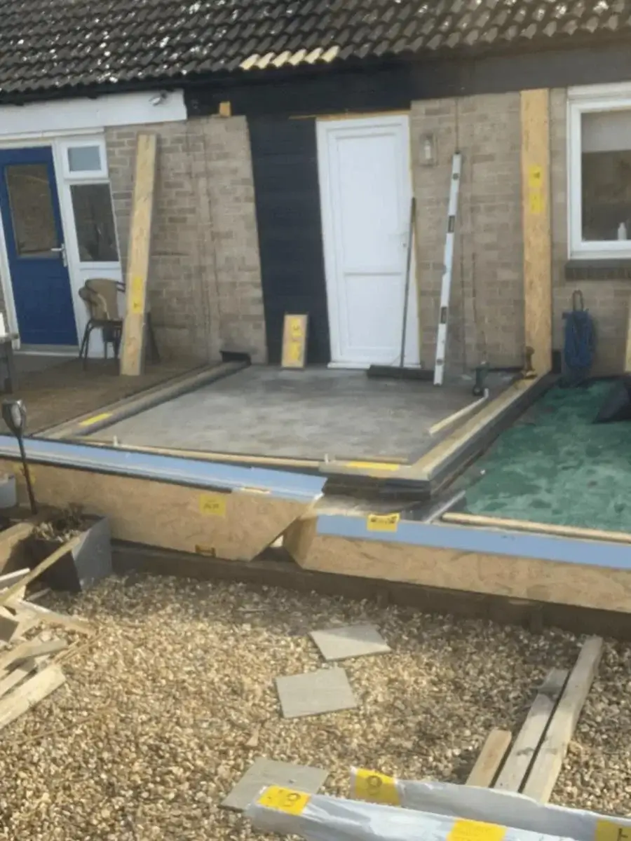 High-performance SIPs wall panels and roof framework being securely constructed on a gravel base by Norfolk Exterior Solutions